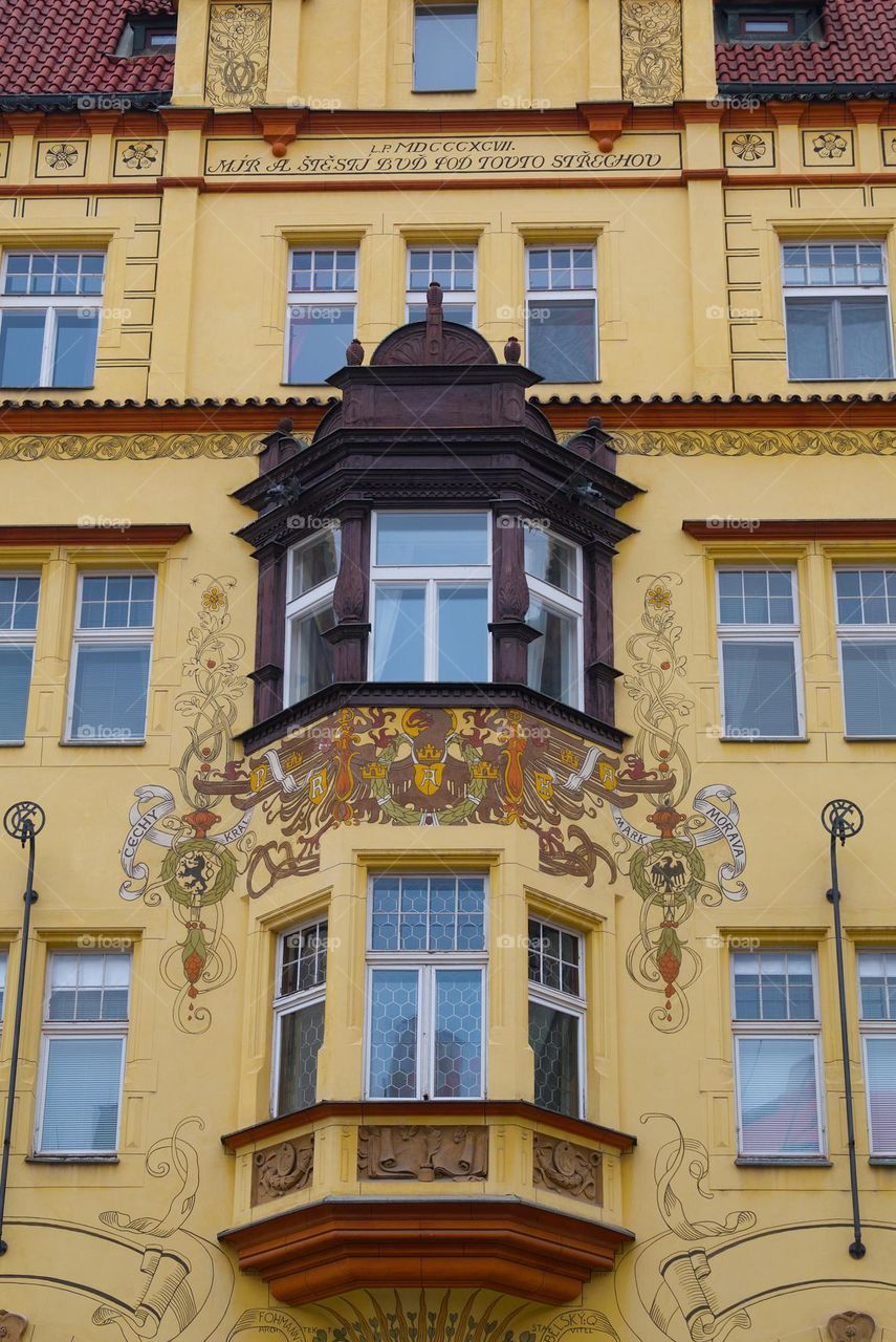 Old historic house with a beautifully decorated facade in Prague.