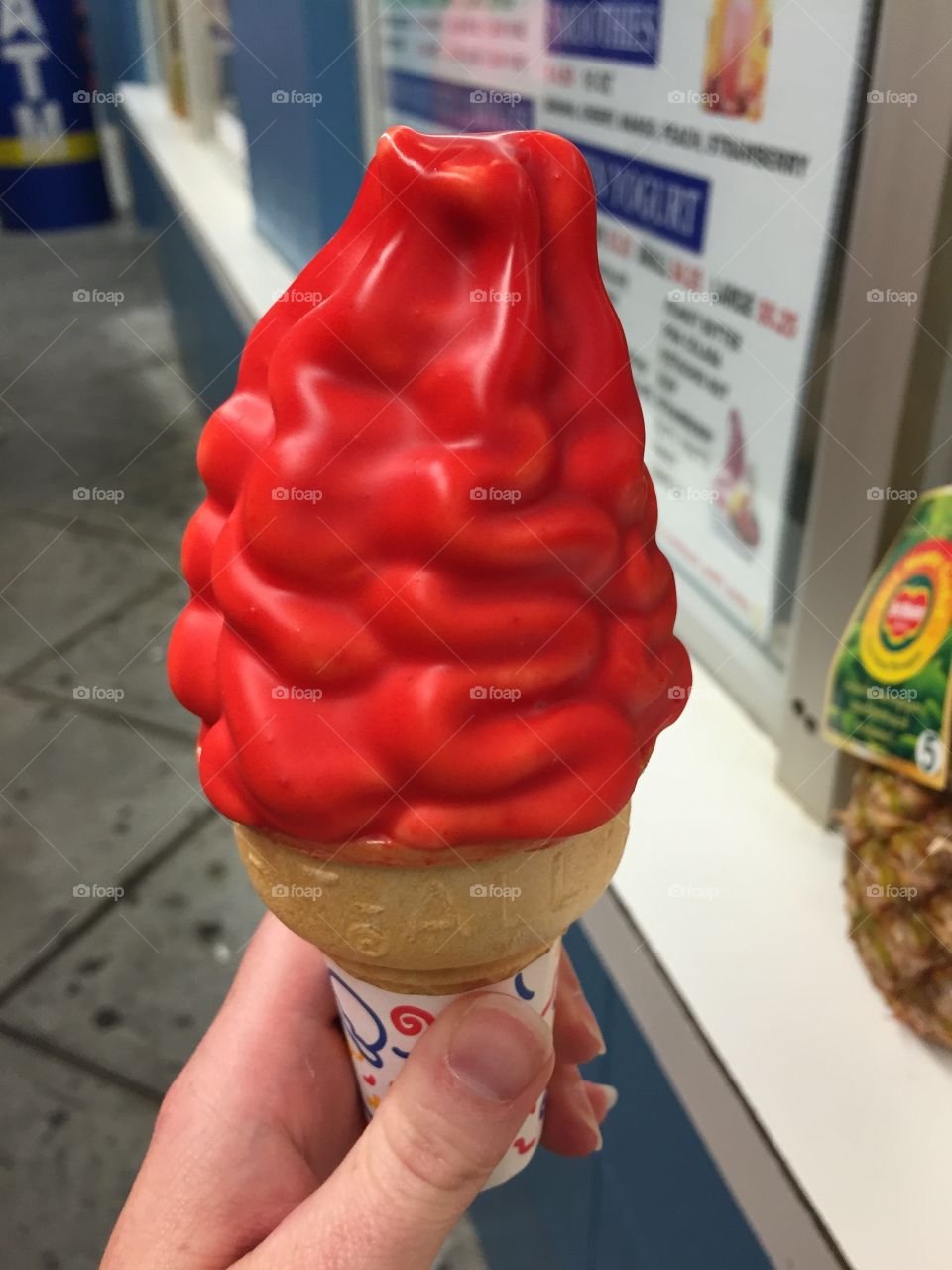 Cherry dipped cone. Someone holding a cherry dipped cone on the boardwalk in Myrtle Beach,SC