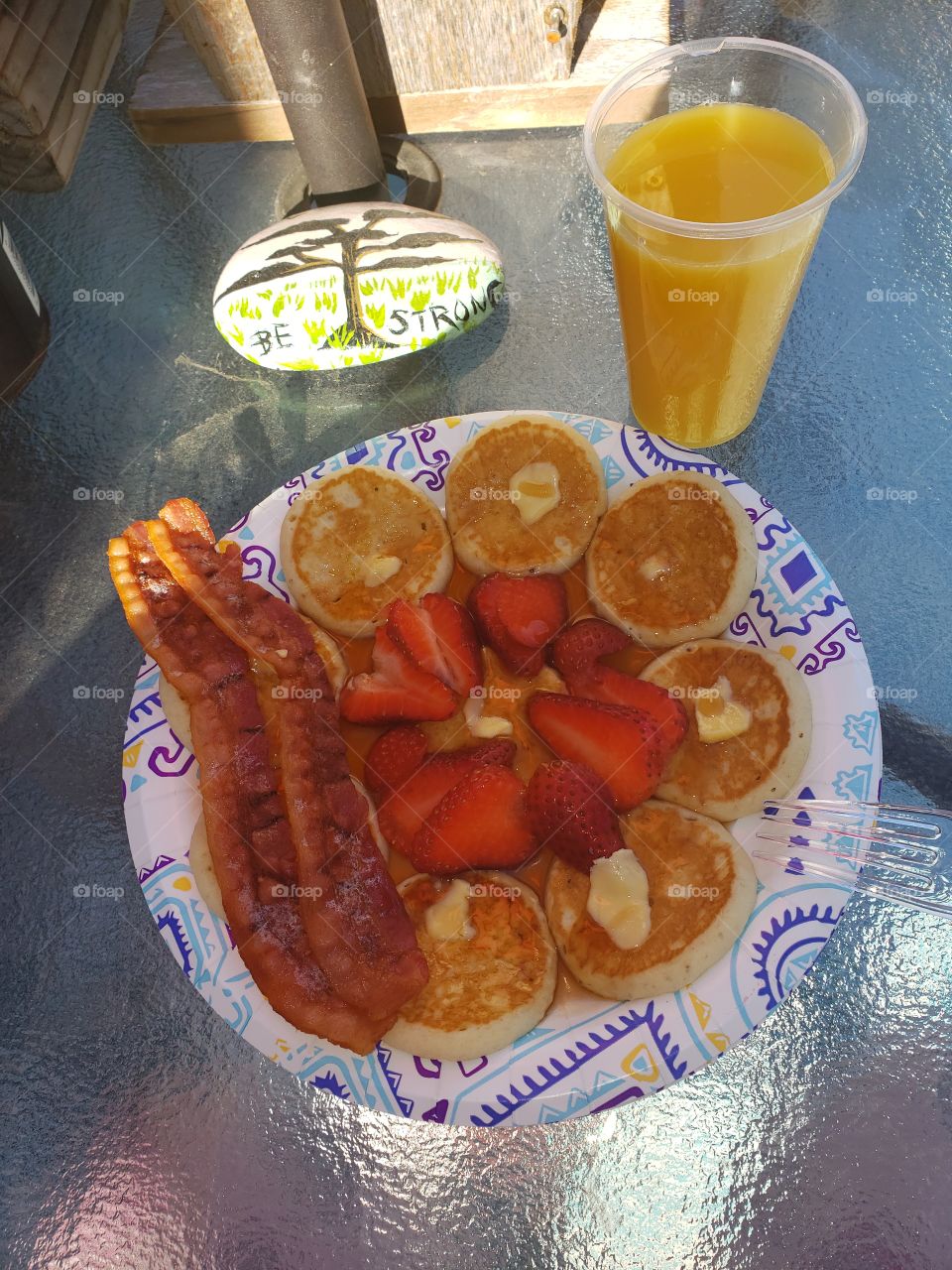pancake, bacon and orange juice breakfast.