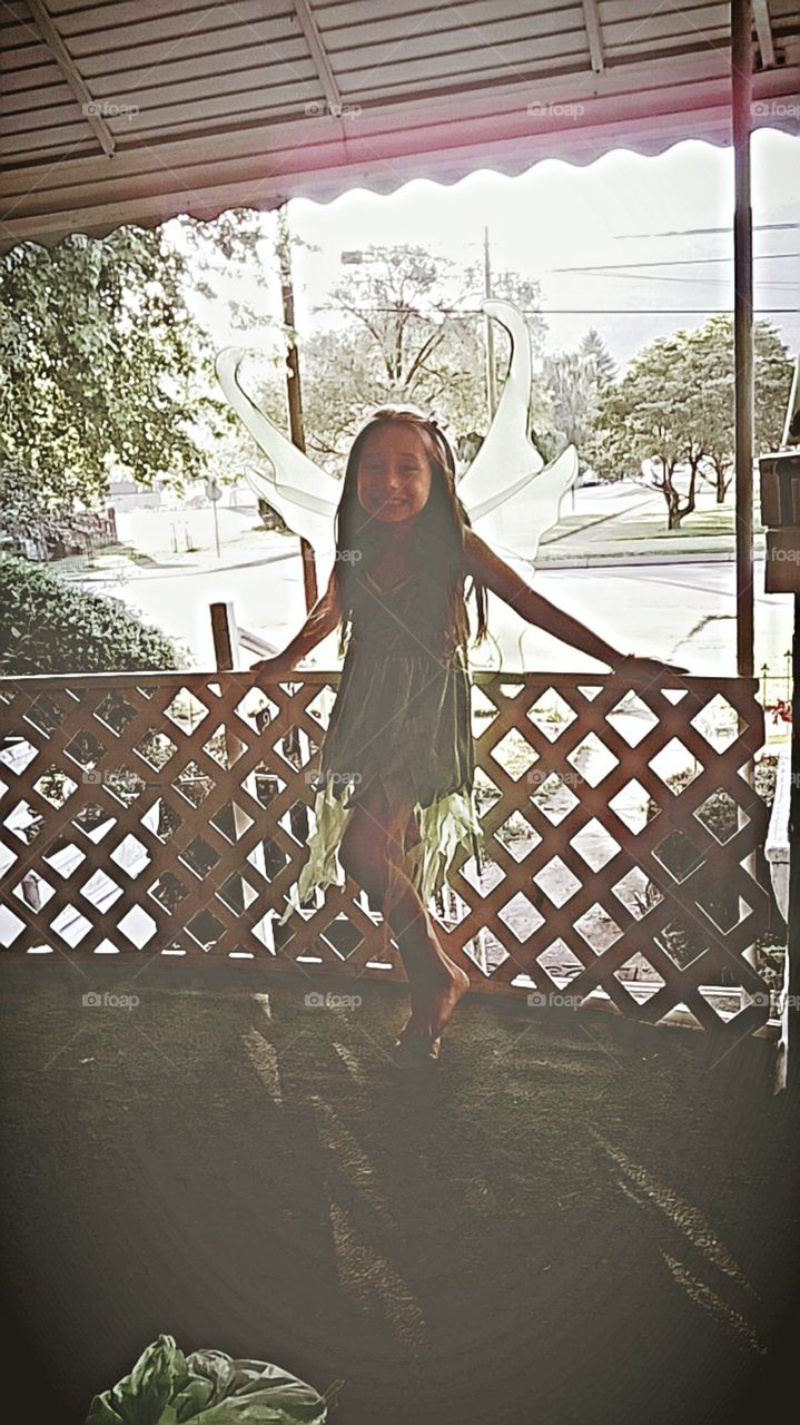 Beautiful, sweet fairy blends right in with the green background.