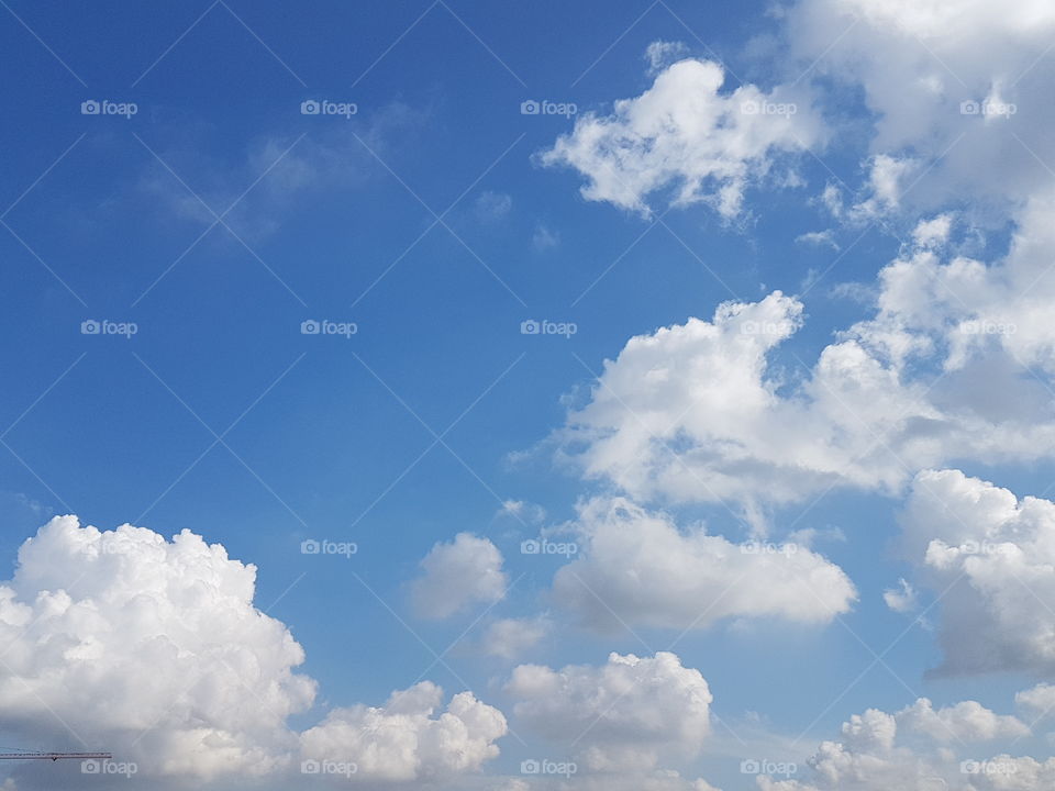 Low angle view of clouds in different shapes and texture computing in sunny blue sky background