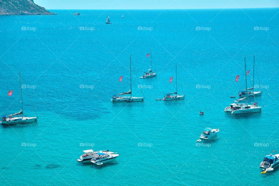 Boats moored in blue sea