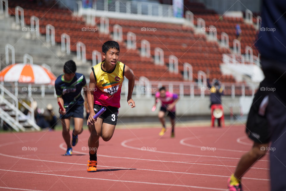 Athletic athlete running in track