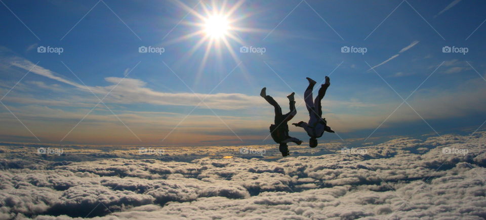 freefly above the clouds. this picture was taken at parachutisme nouvelair in 2007. 2 friends just free flying abouve the clouds