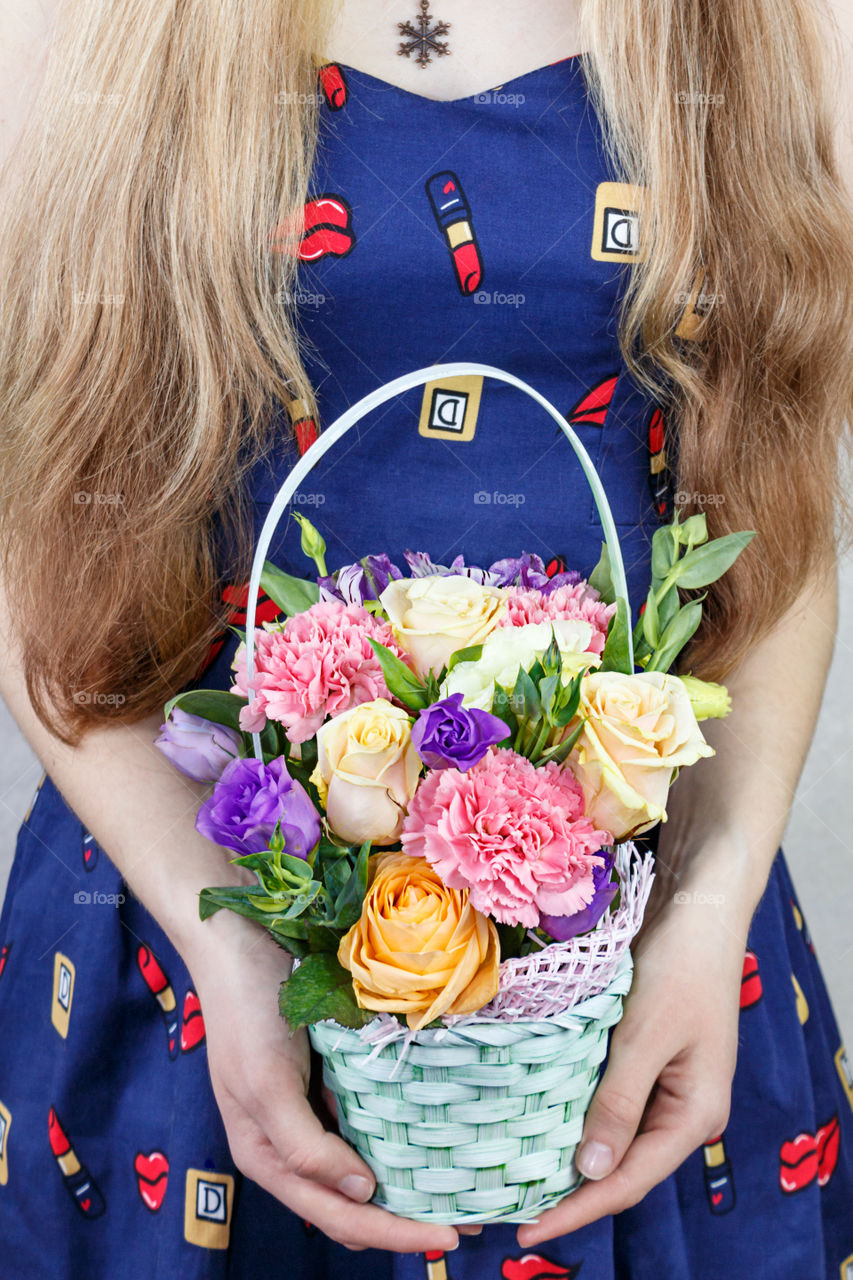 Girl with a basket of flowers