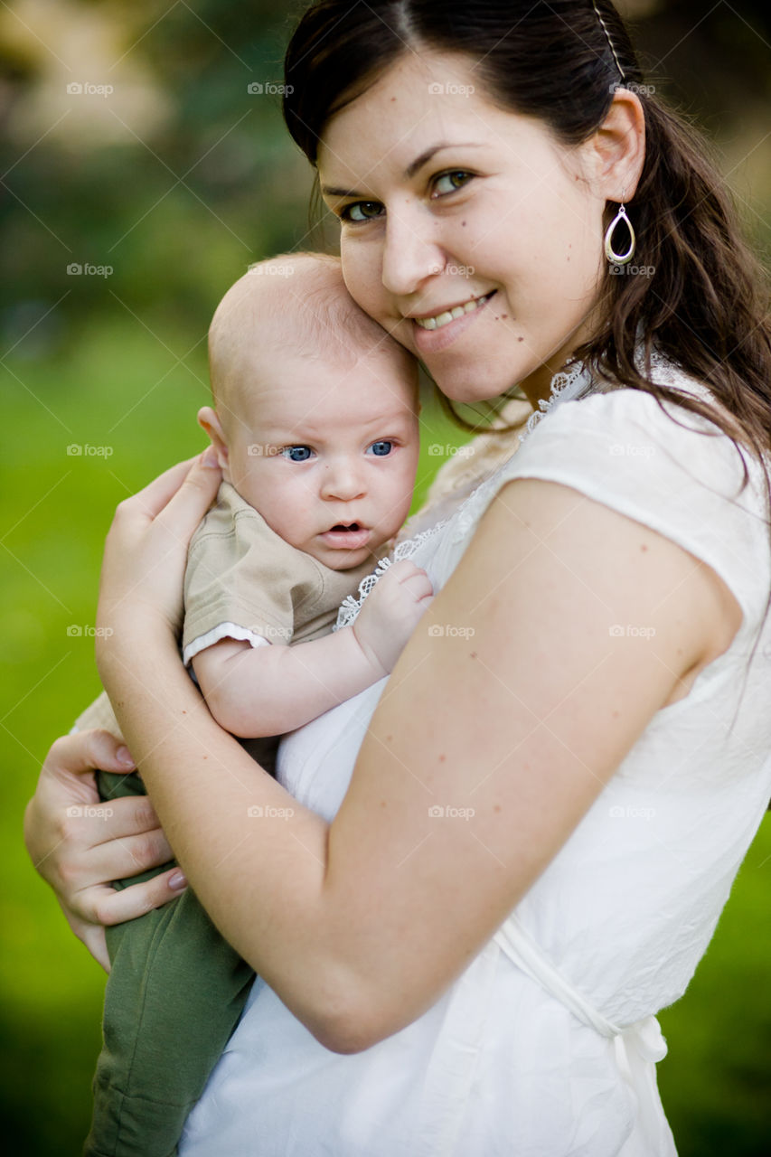 Young mom holding her 6 month old baby boy 
