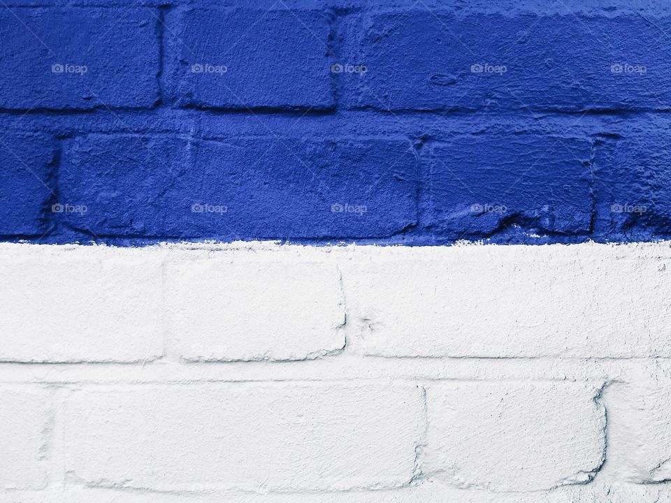 Blue and white brick wall texture closeup 