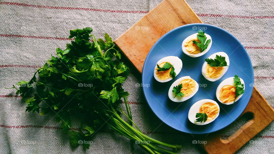 cut boiled eggs decorated with parsley