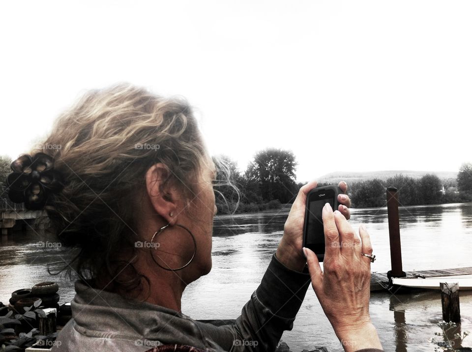 Woman with smartphone lining up a photo shot. Woman with smartphone lining up a photo shot