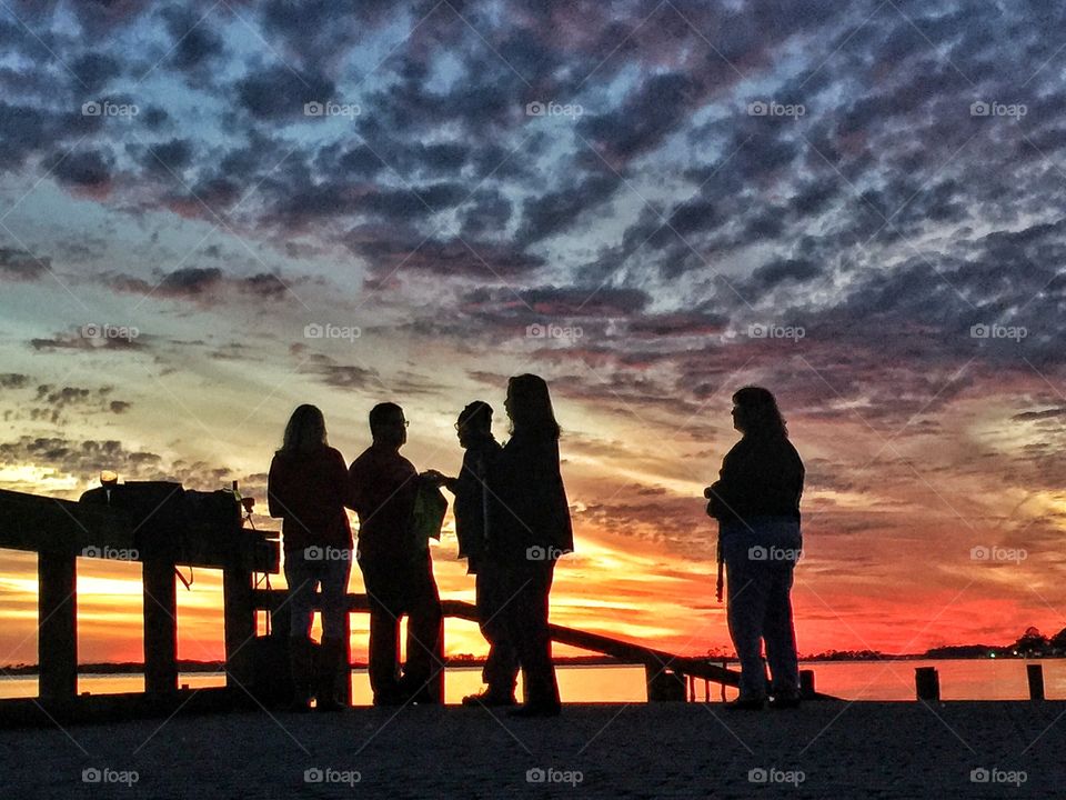A group of people to enjoying a magnificent sunset