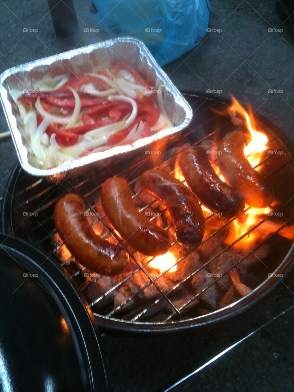 Tailgating at the Steelers game. Cooking Italian sausages, peppers and onions on the grill. 
