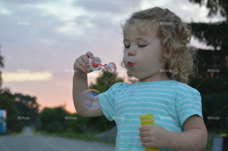 Girl trying to makes bubbles