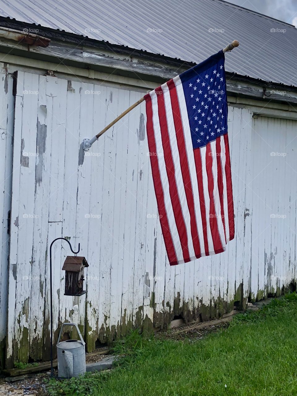 Old barn and  old glory vintage watering can 