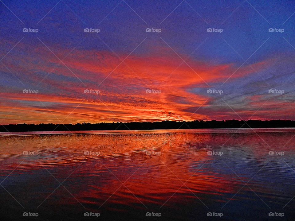 
Mesmerizing sunset - Bright streaks of red, pink, and orange slowly overcame the dark blue and purple of the twilight sky.