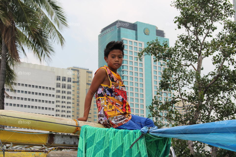 Boy watching boat races at Manila Bay Philippines 