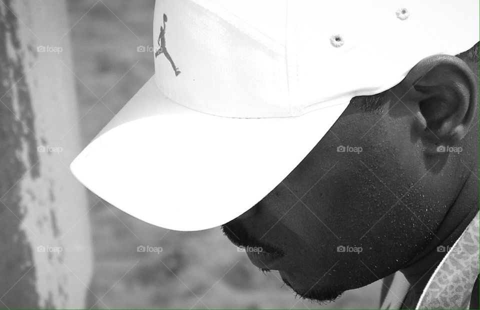 Profile of man in Nike Hat