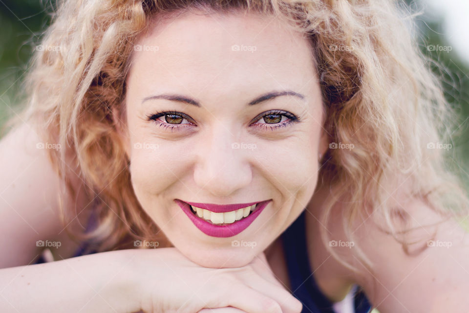 curly blond girl. closeup portrait of a young blond and curly girl