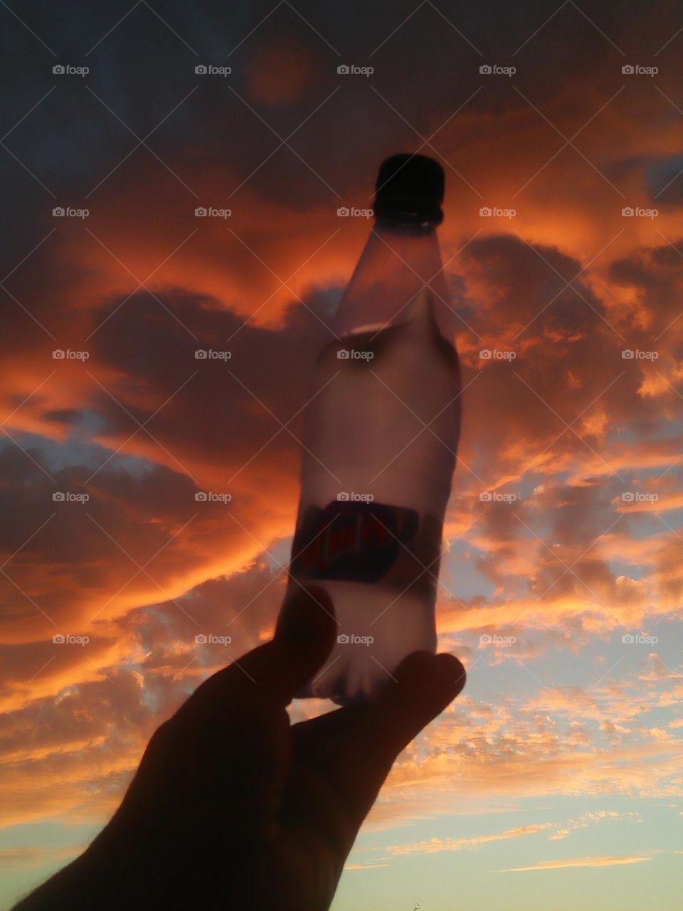 Magic sunset and a beautiful bottle embraces high sky.