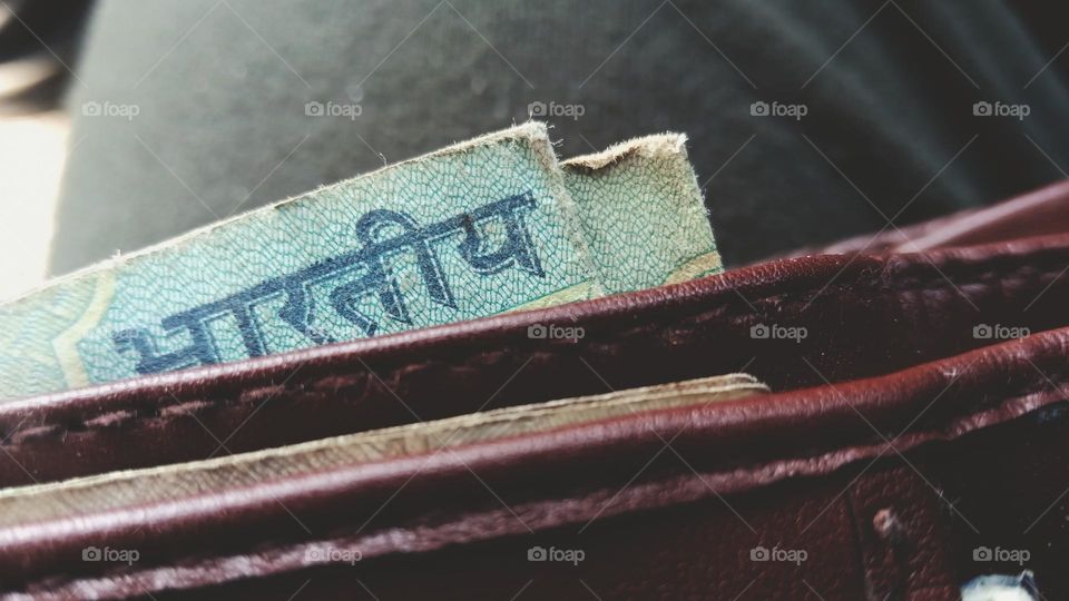 money bill coming out of wallet.