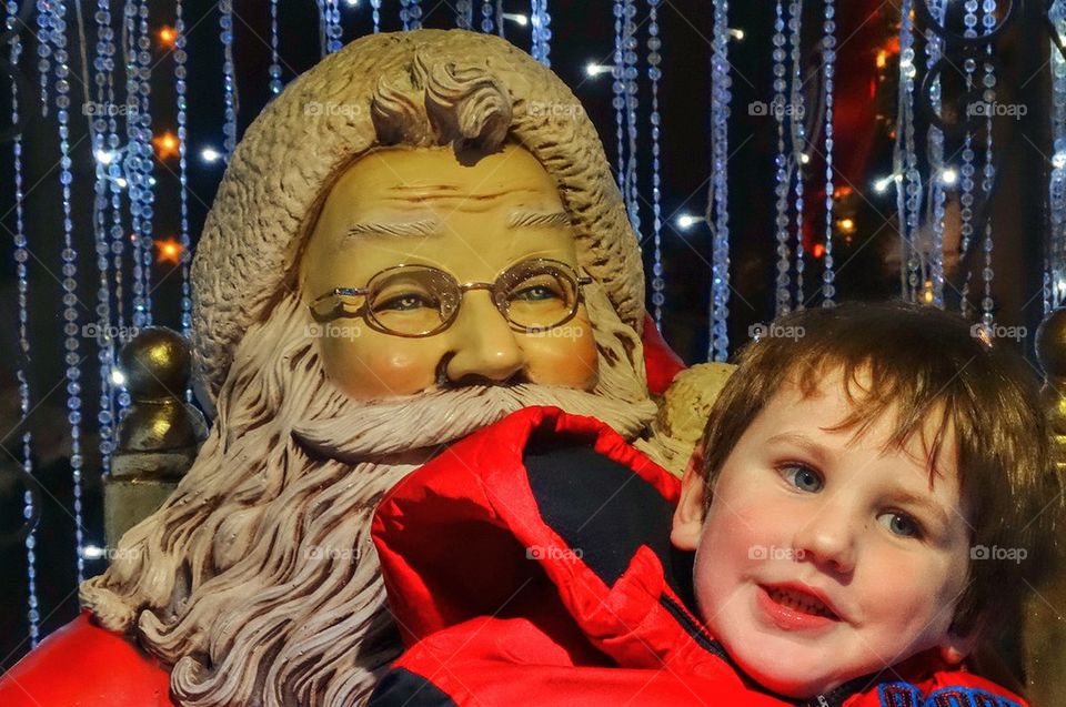 Boy Sitting With Santa Claus. Christmas Cheer