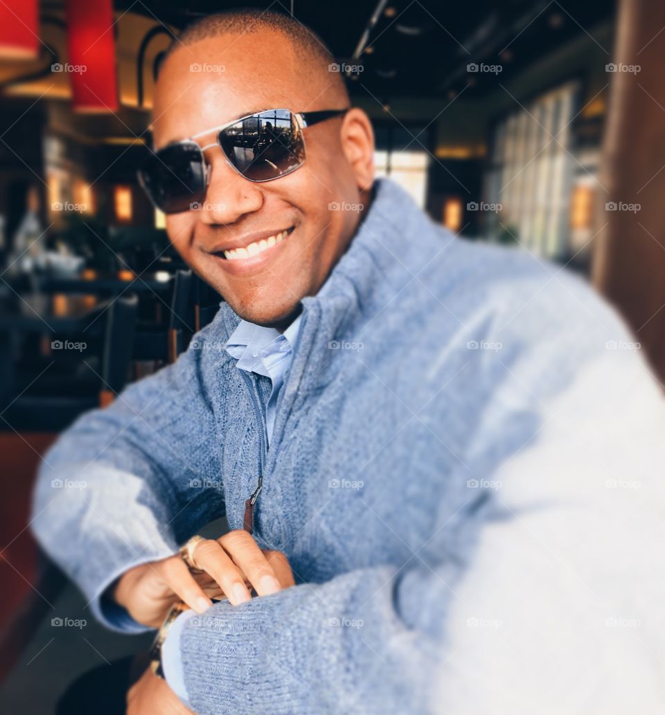 Close-up of a happy african man wearing sunglasses