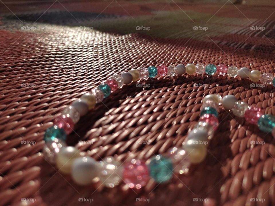 reflection of sunrays on beads and shadow