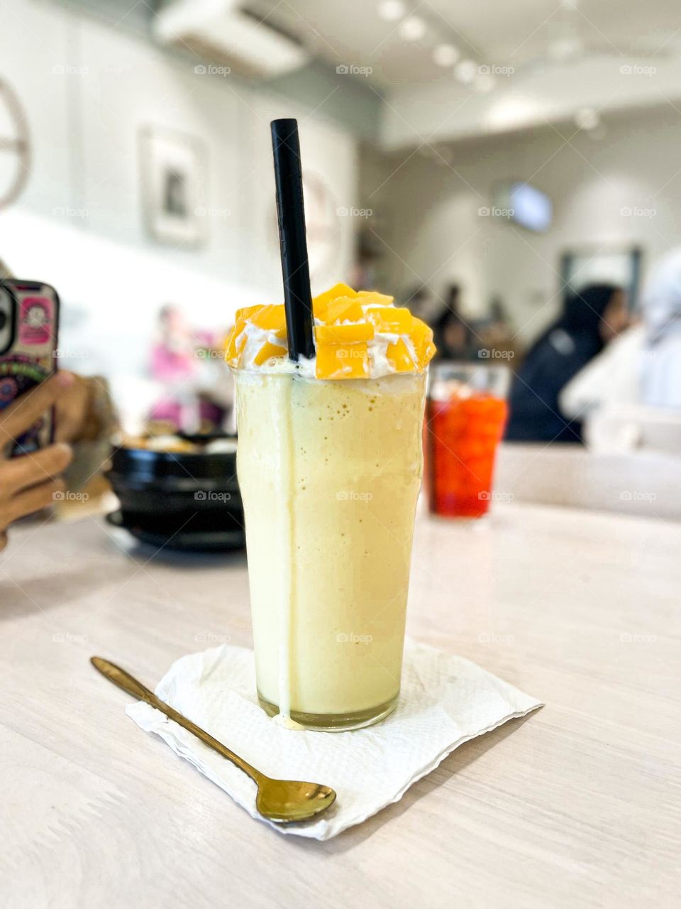 Mango smoothie isolated on a cafe table