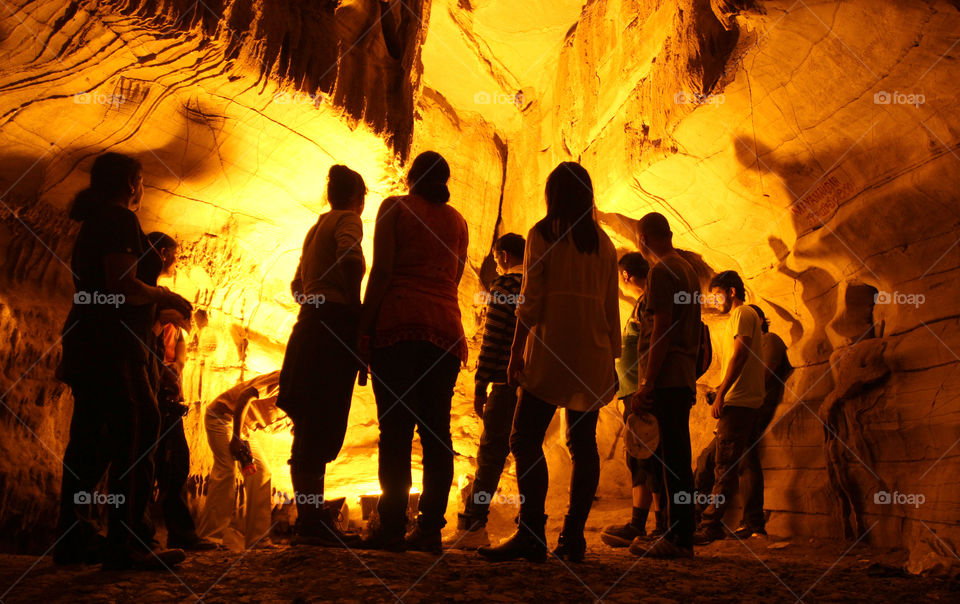 Silhouette in cave backlights