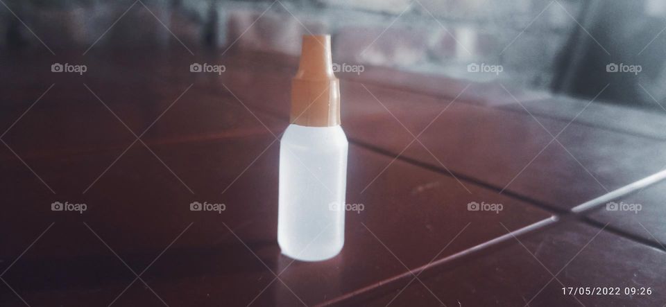 Bottled drops enlightened on table
