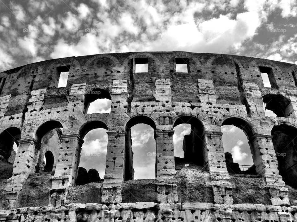 Black and White shot of the Colosseum in Rome, with clouds 