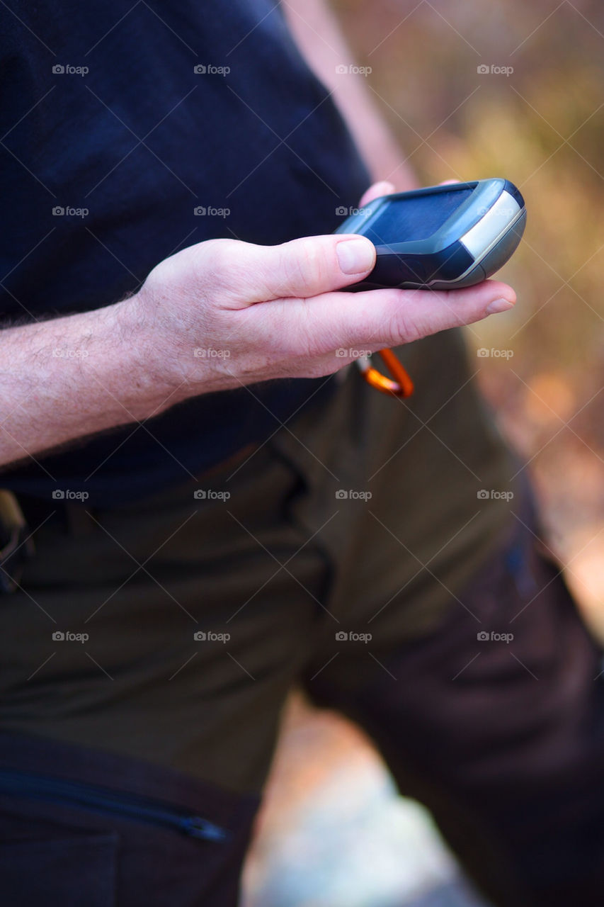 Man is holding gps unit