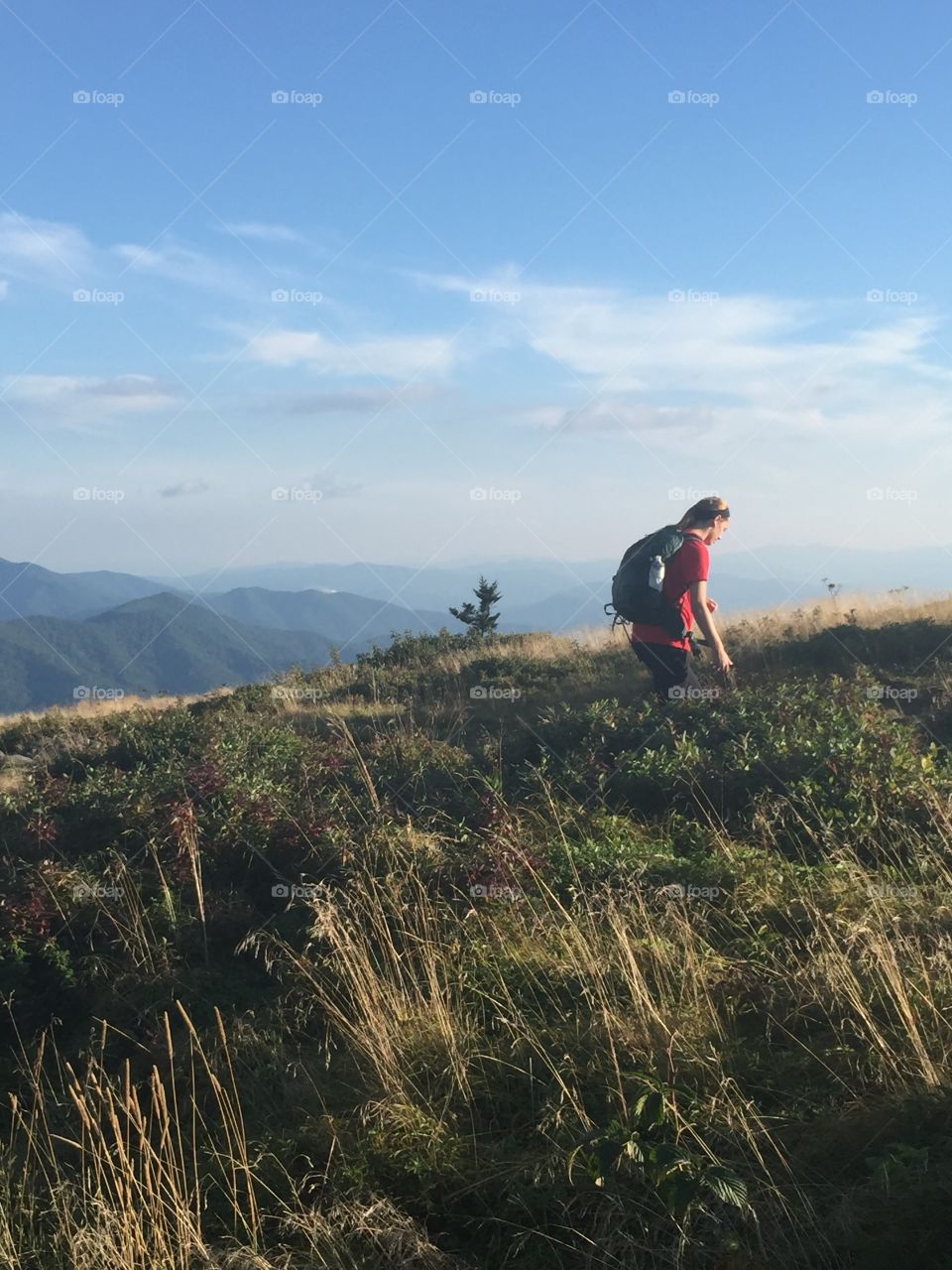 Young woman backpacking in the beautiful blue ridge mountains