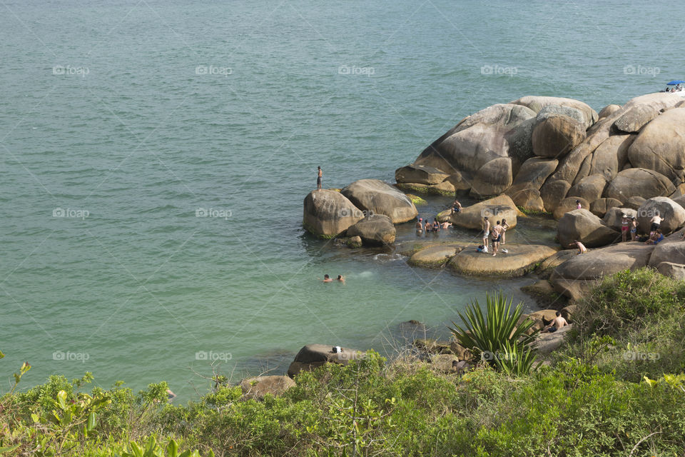 Tourists enjoy the summer in natural pools in Barra da Lagoa in Florianopolis Santa Catarina Brazil.