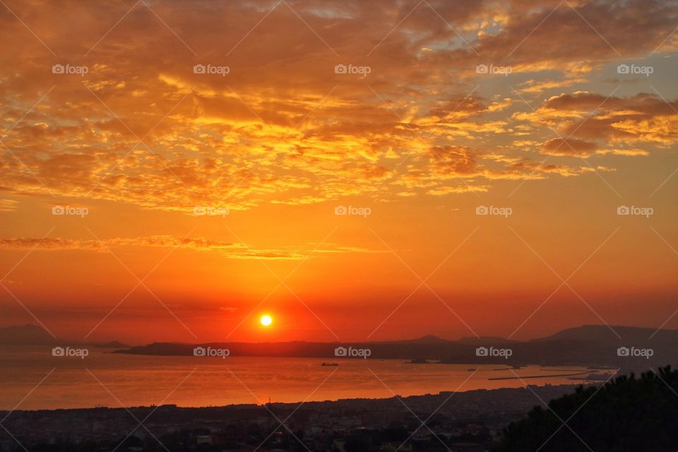 Dramatic sky over Naples city at sunset