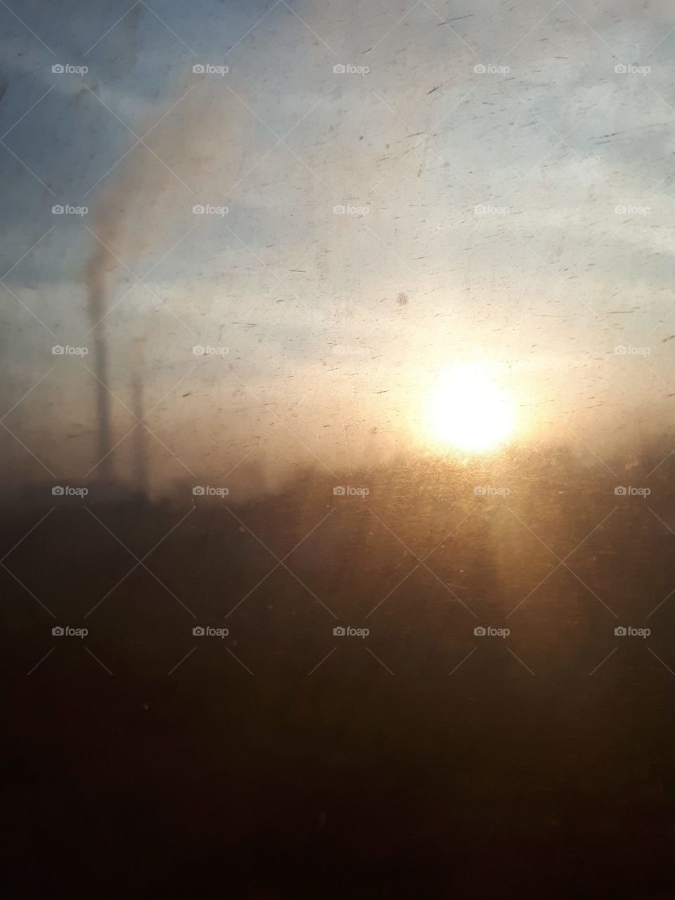 a view of the sunset through the window of the old passenger wagon