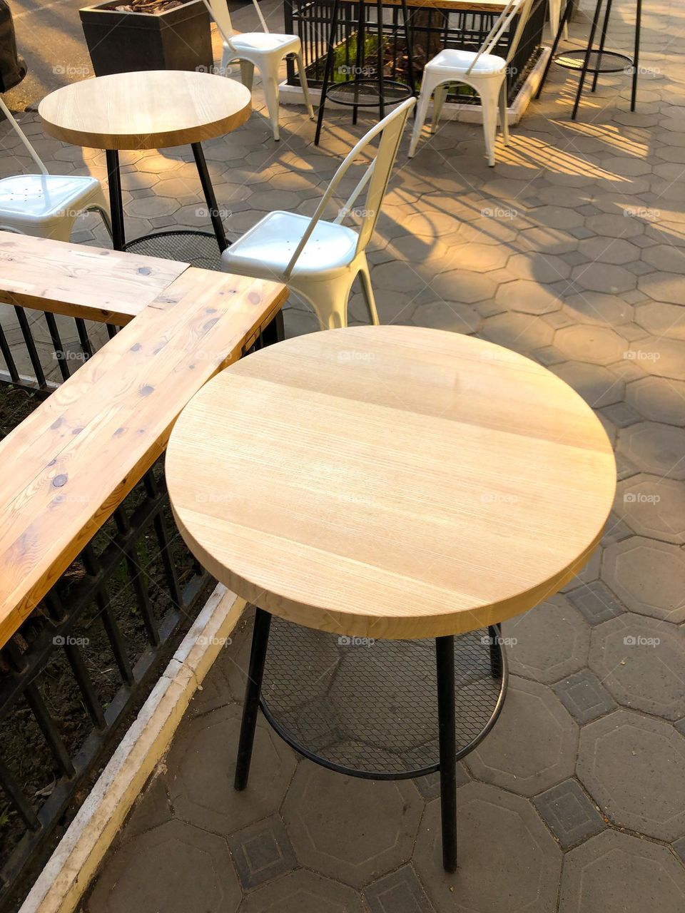 Circle wooden tables on the street 