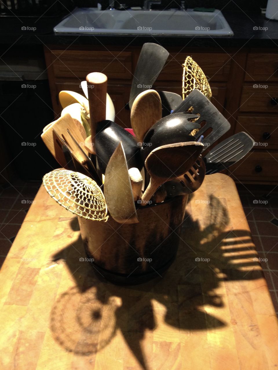 Kitchen tools in container at hands reach. Anything needed is right there! Oak chopping block from restaurant! Sink in background.