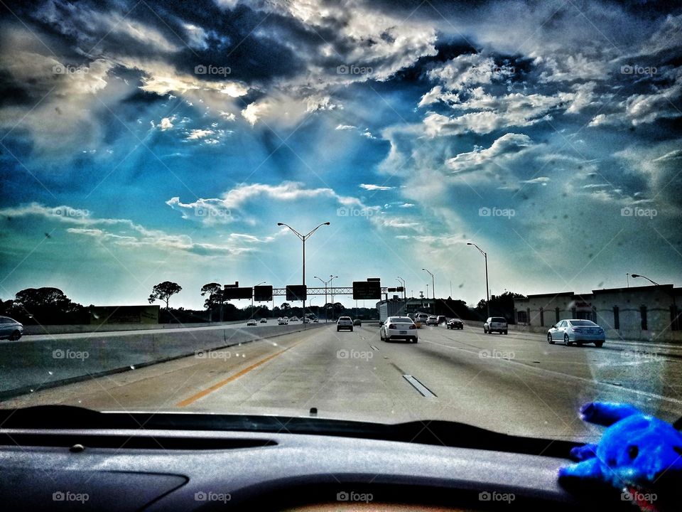 Expressway with bright blue skies and puffy clouds