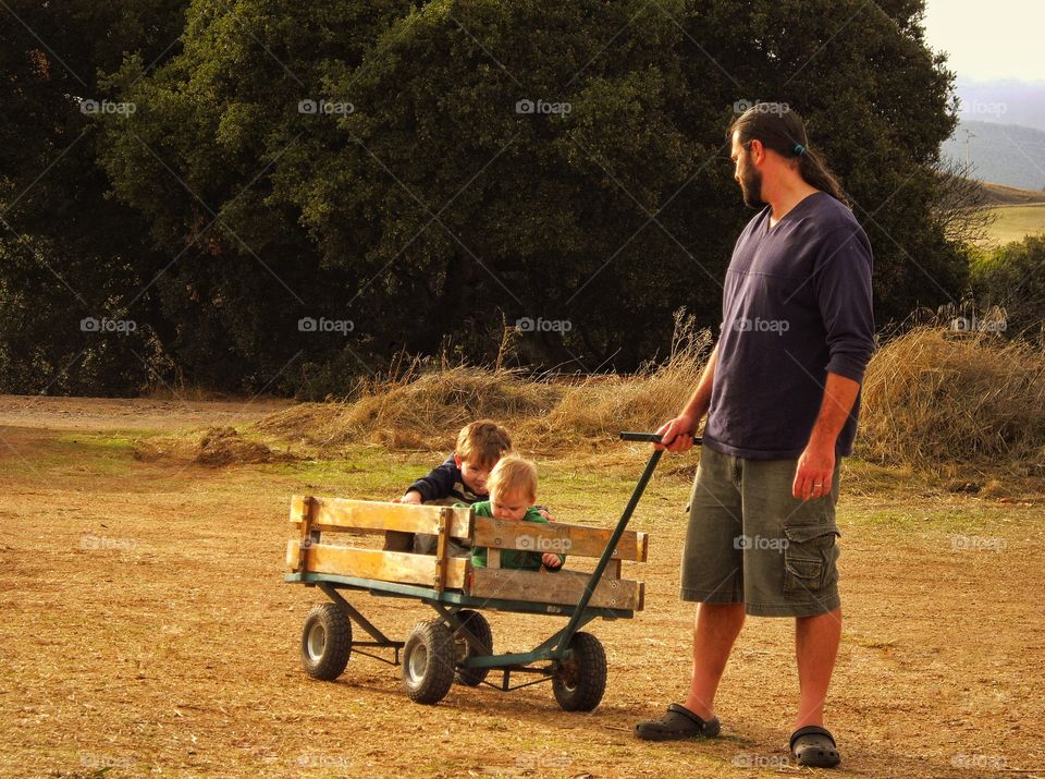 Dad Pulling Kids In A Wagon