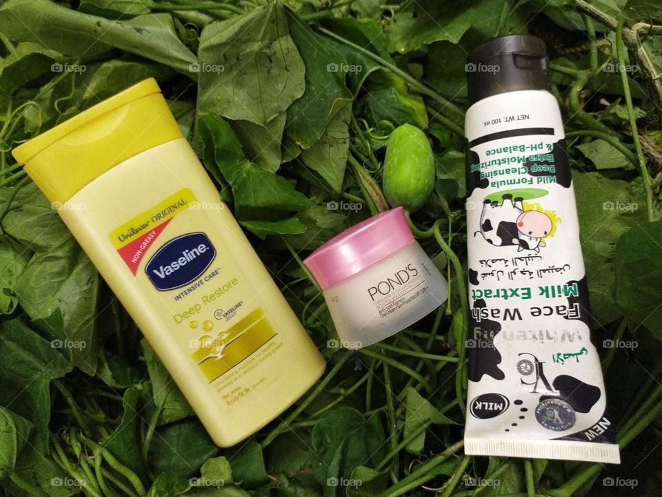 Cosmetics products green background