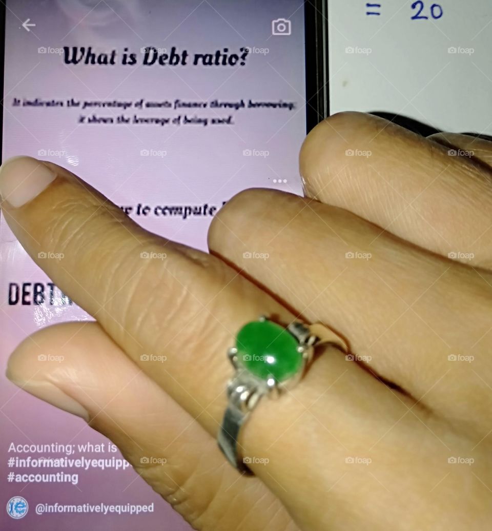 Wearing natural polished green Jade stone ring.