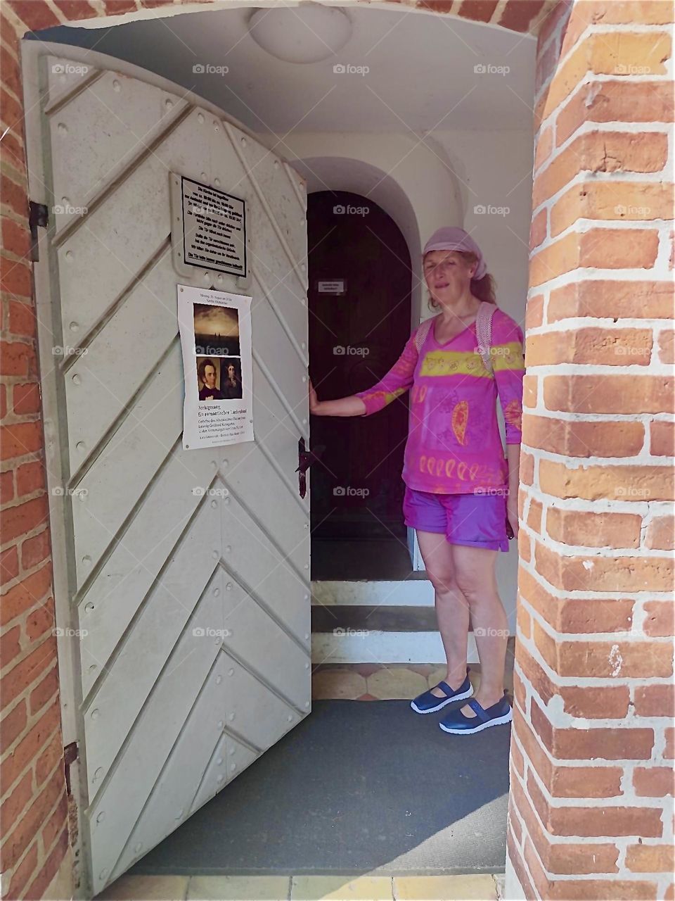 The door of the brownstone medieval church of “Altenkirchen” on the island “Rügen” in the “Baltic Sea” or “Ostsee” in “Western Pomerania”, Germany opens and is about to reveal its palatial interior. 2024. Hypnotic Productions