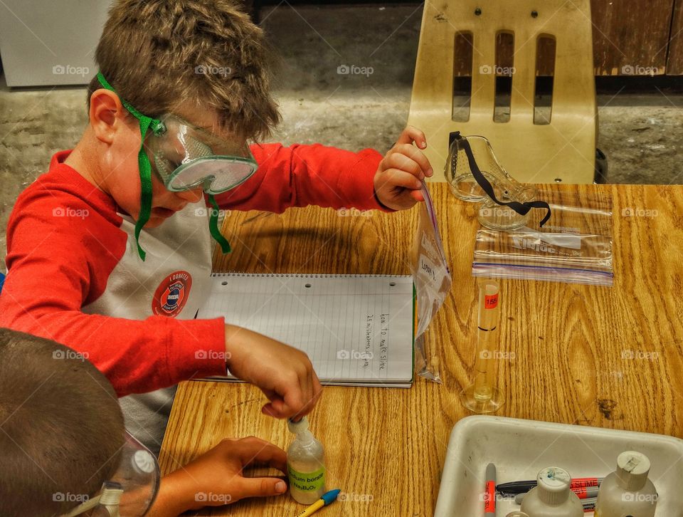 Desk From Above. Children Working On A Science Project
