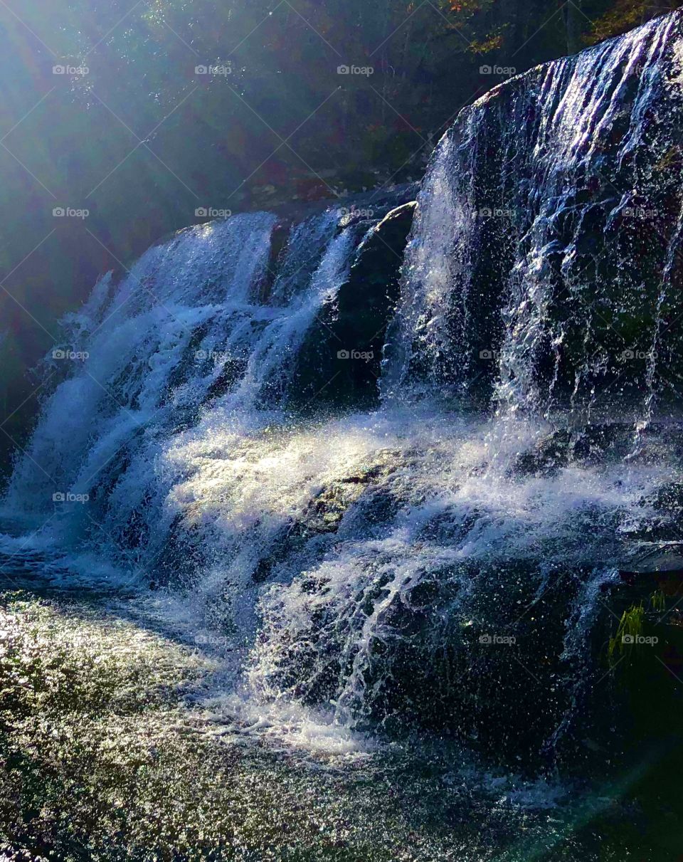 Closeup of sun and shadow on waterfall 