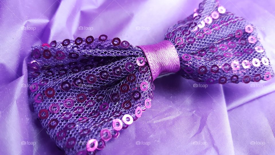 High angle view of bow against purple background