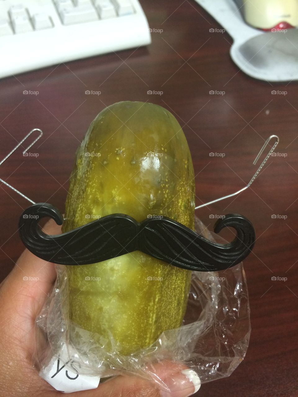 Circus pickle . Giant pickle flexes paper clip arms