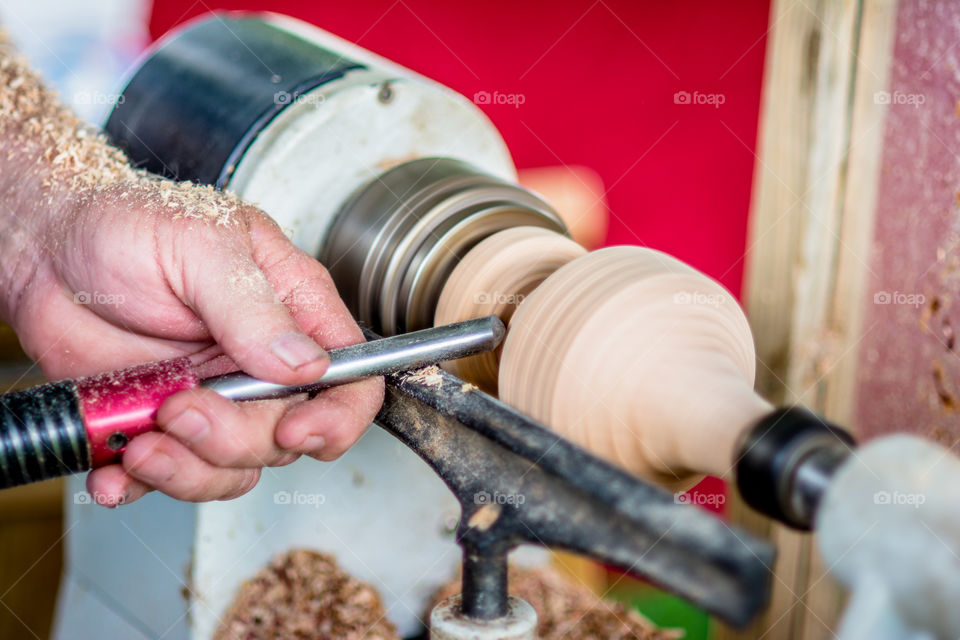 Man Turning Wood on a Lathe Making an Ornament 