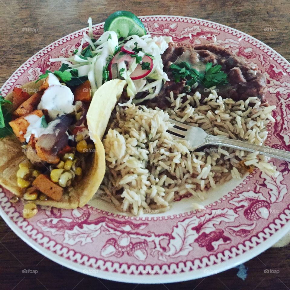 Garden vegetables- sweet potatoes, onions and corn, in a corn tortilla with cabbage and radish salad, homemade refried beans, and brown long grain rice. Summer is coming!