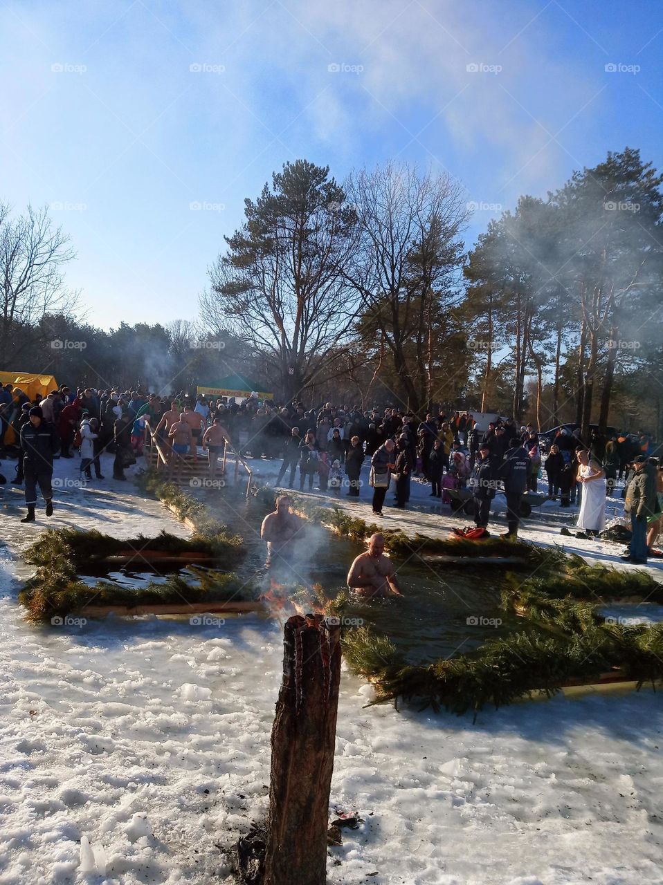 Introducing the crowds revolution! baptism, many people at the feast of baptism, baptism on the lake, fire, cleansing, crowd around the lake with an ice hole