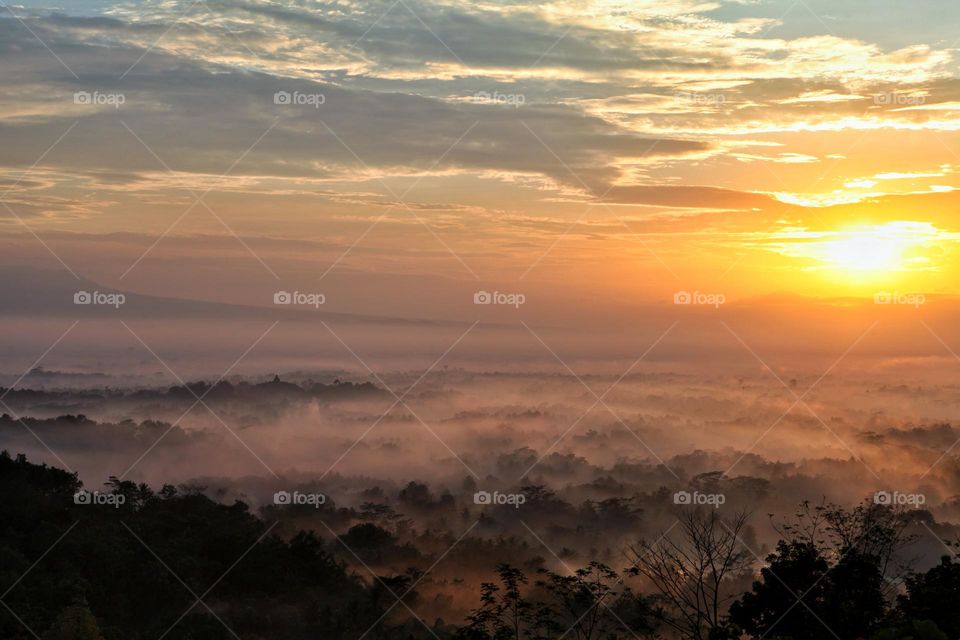 Borobudur temple from a distance during sunrise 